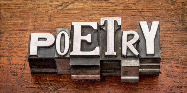 poetry word in mixed vintage metal type printing blocks over grunge wood